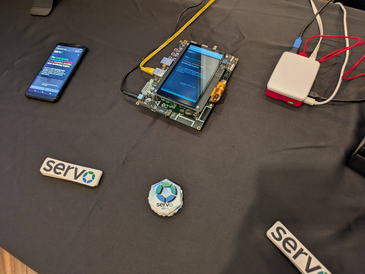 Close up picture of the Android phone, Rapsberry Pi 5 and Open Harmony board (Rockchip rk3588) running Servo. Some Servo stickers can be seen too.